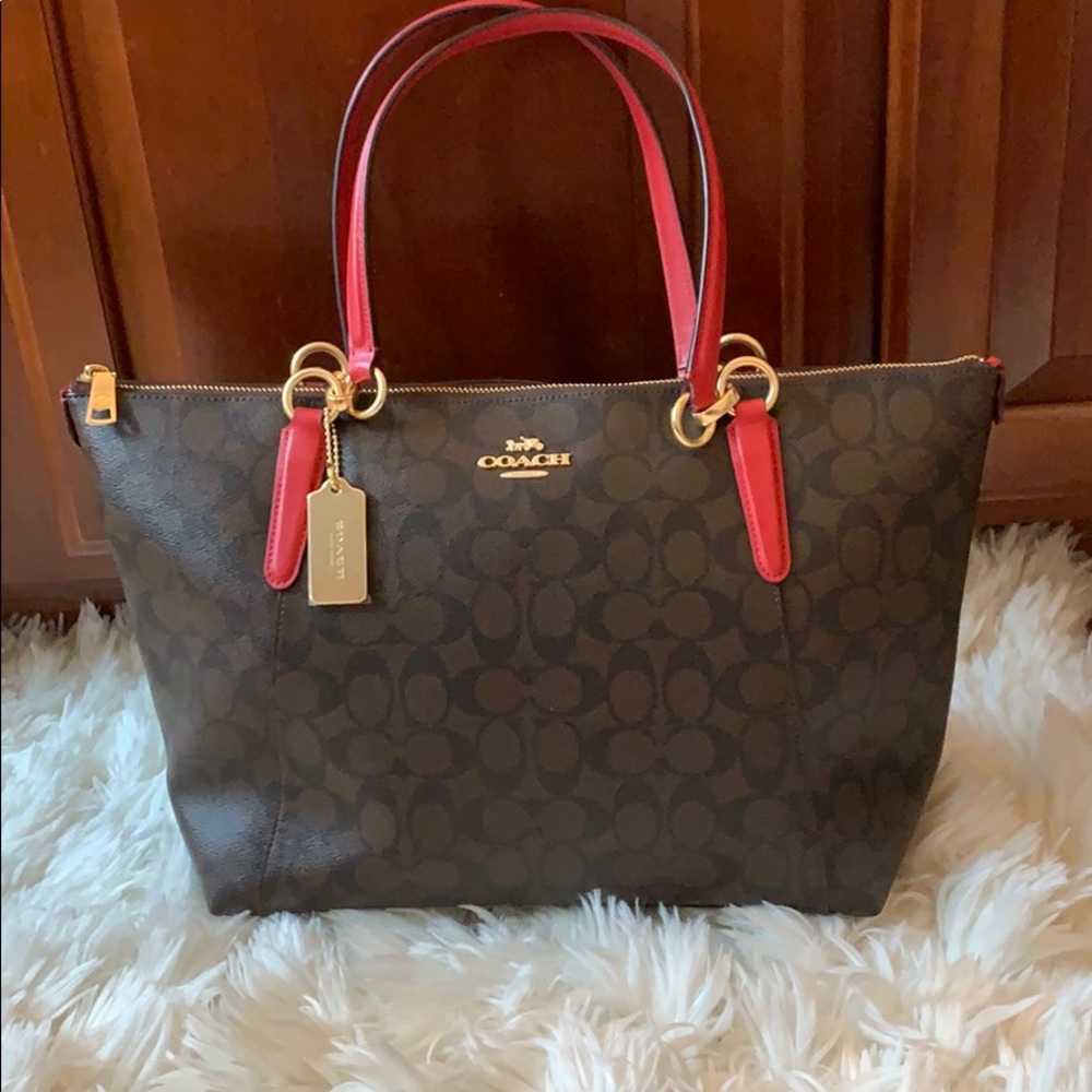 Brown with red strap Coach Tote.